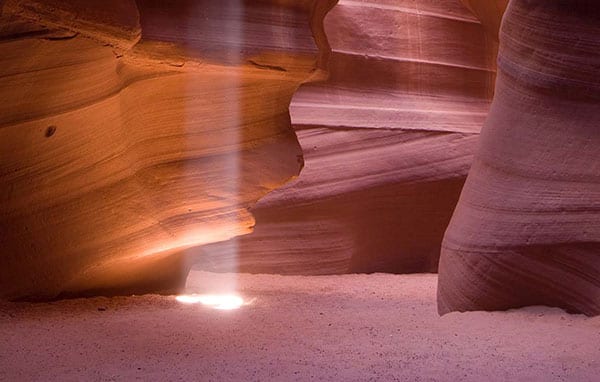 red and orange canyon rocks with lightbeams