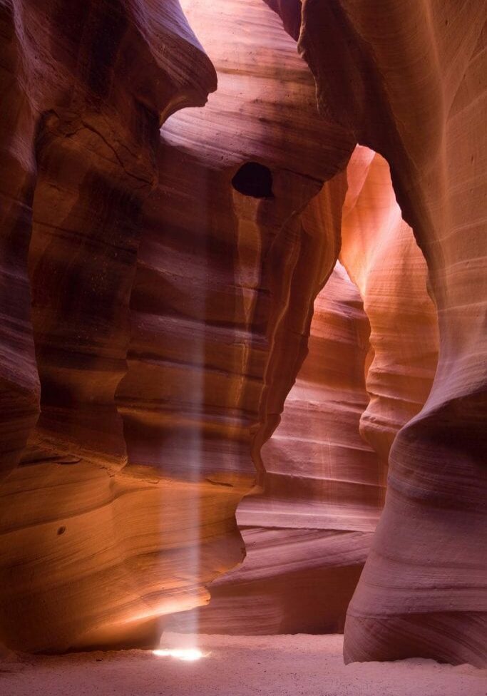 red and orange canyon rocks with lightbeams